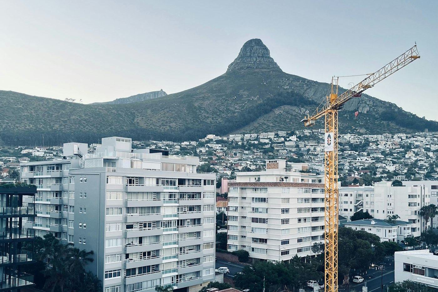 A tower crane over a Cape Town building site, with Lion's Head behind